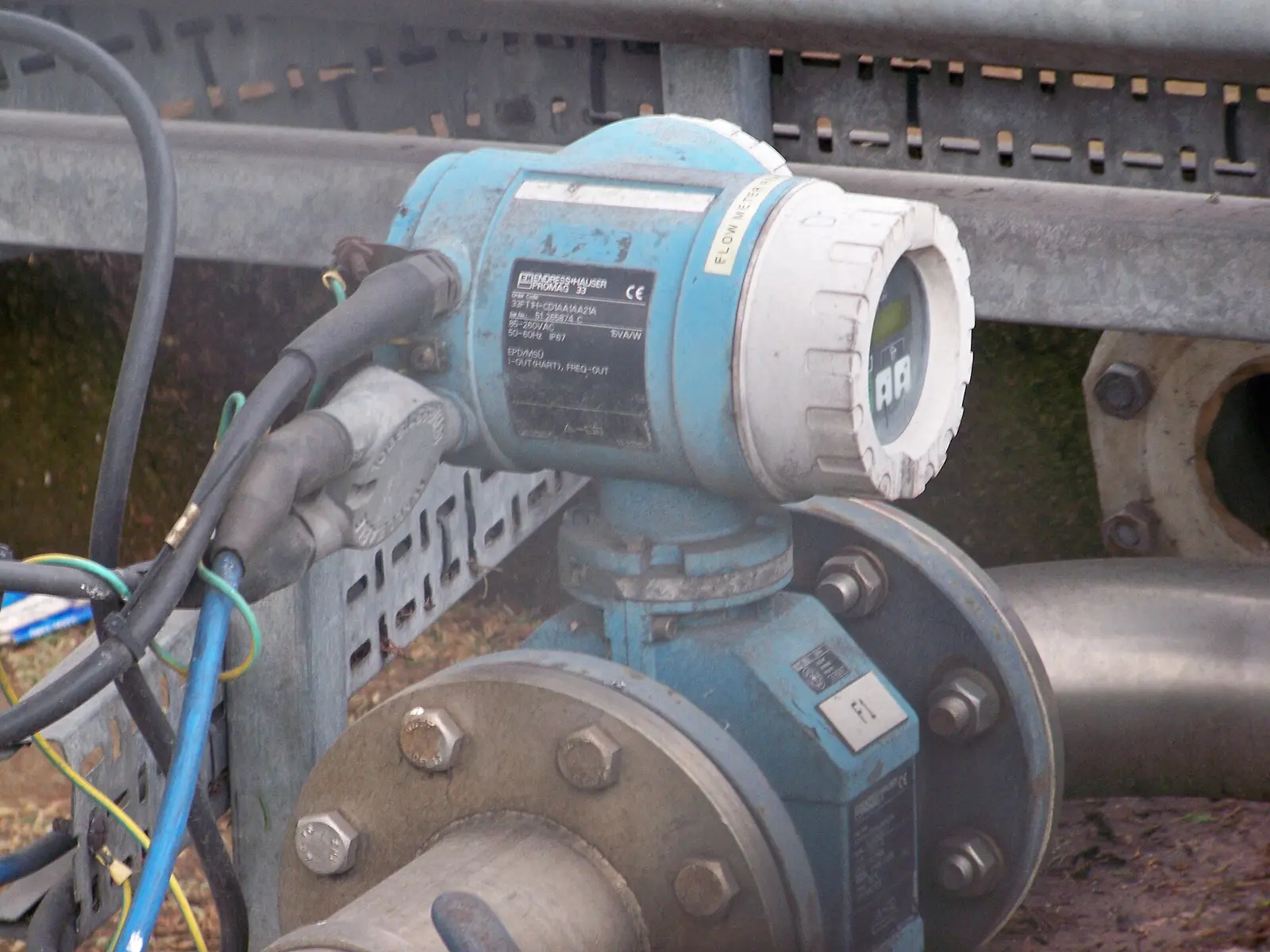 Electromagnetic flow meter, a flanged full-bore sensor with mounted transmitter head installed in a pipeline