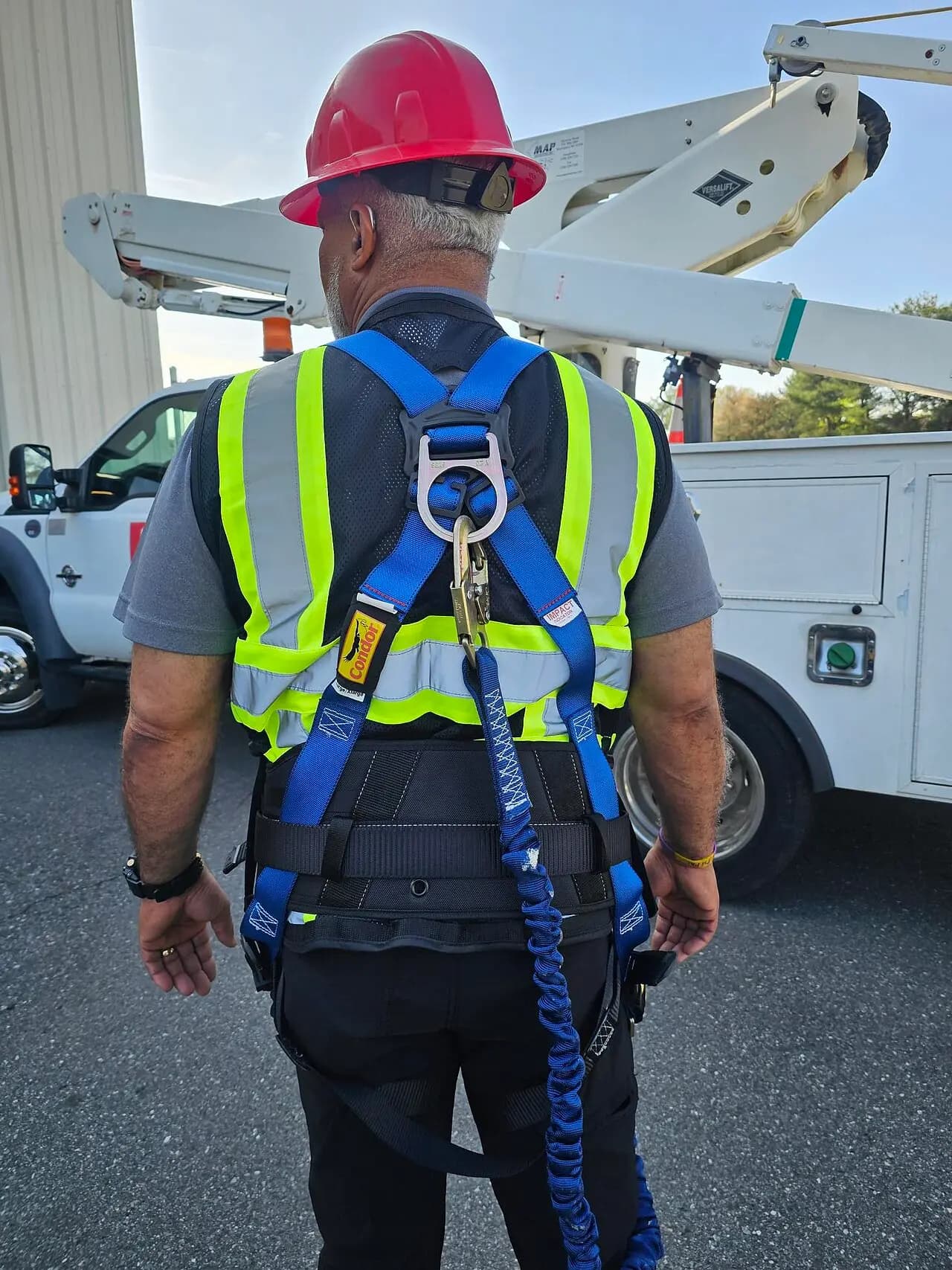 Worker wearing a full-body safety harness